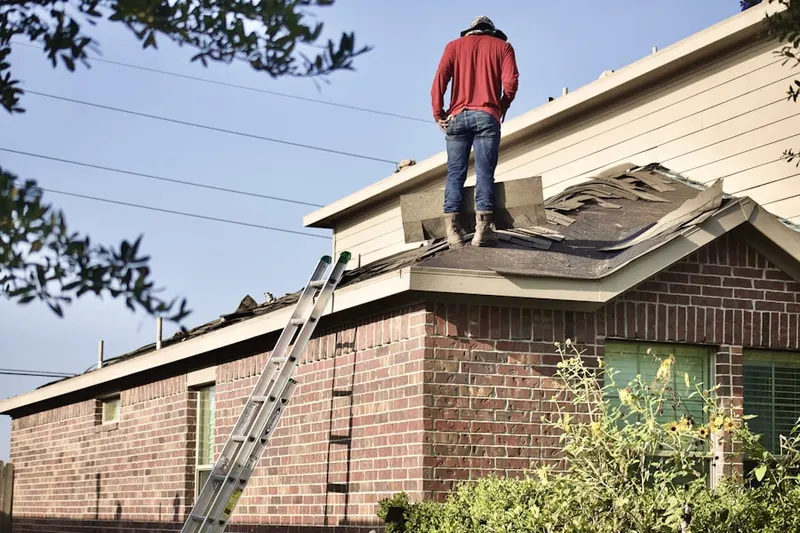 Professional roofer working on a residential roof in Kingswood Estates